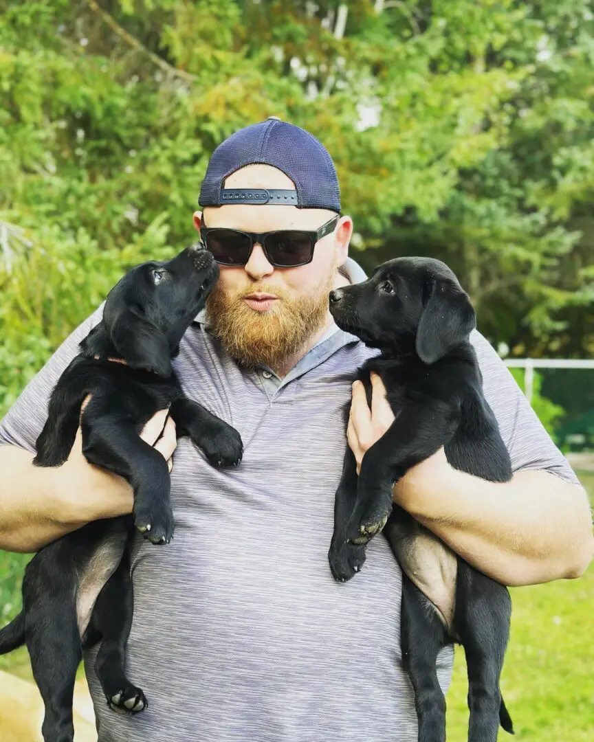 Jon with Black puppies